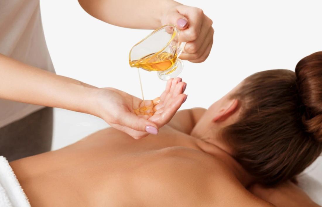 A woman getting olive oil massage