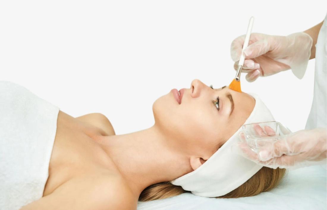A woman laying down having facial by professional