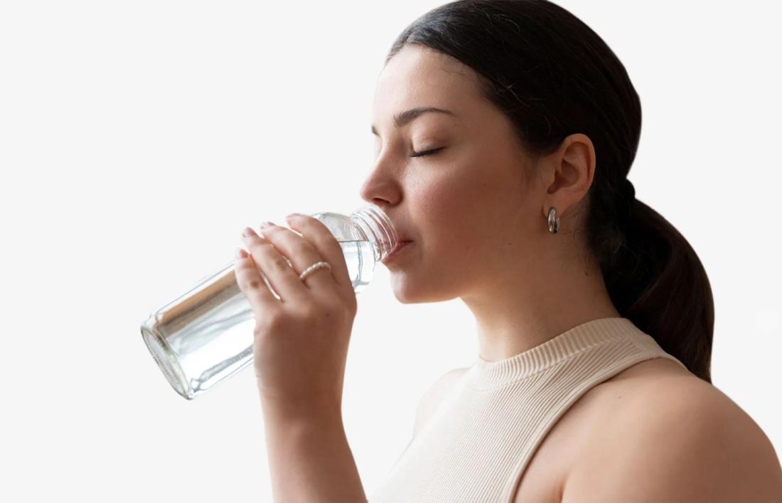 A Woman Drinking Water to get hydrated