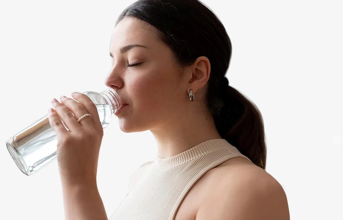 A female drinking a glass of Water