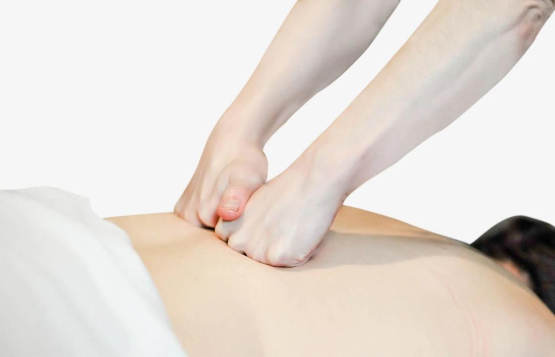 A Woman getting back massage using Effleurage Strokes