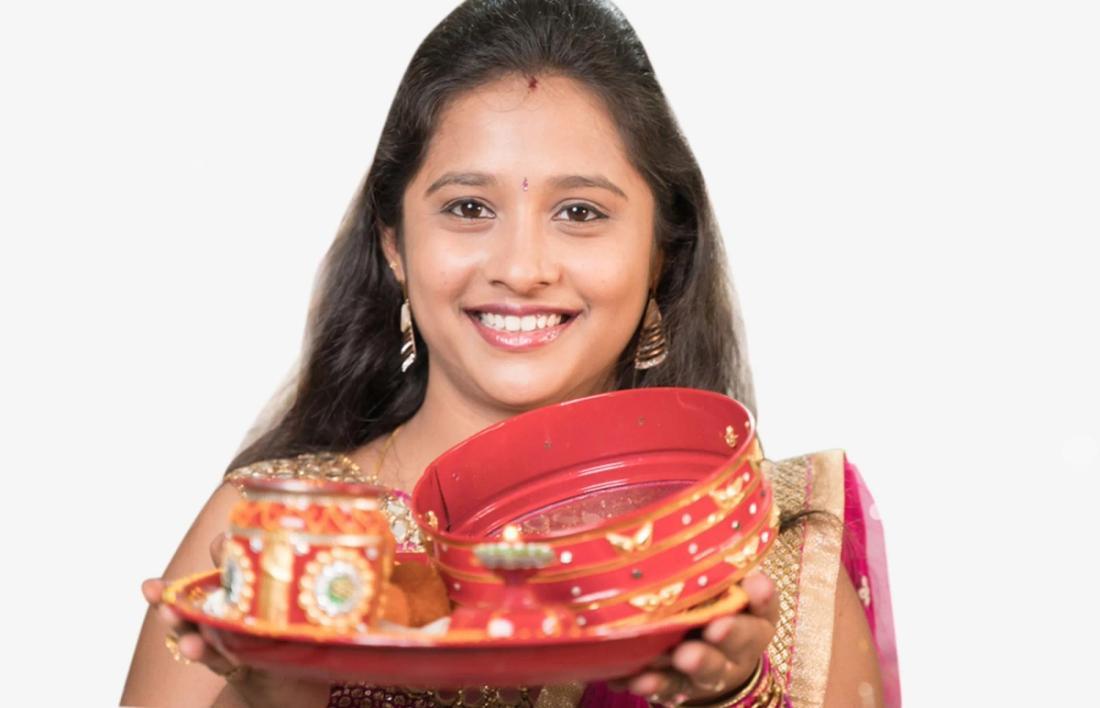  A woman standing with pooja thali for karwa chauth
